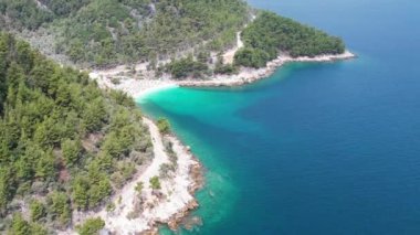 Ege Denizi 'ndeki Yunan adası Thassos' taki turkuaz sularıyla güzel Marble Sahili 'nin havadan görünüşü. Bir yaz günü beyaz kumlu berrak mavi suyun insansız hava aracı görüntüleri.