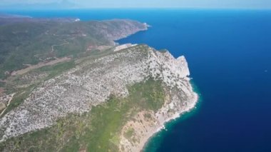 Avrupa 'nın Grece kentinde yeşil ağaçlı Sithonia yarımadasındaki mavi deniz suyunun havadan görünüşü. Pelerinin drone görüntüsü