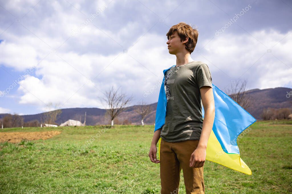 A man holds the Ukrainian flag . Stop war. Against the backdrop of mountains.