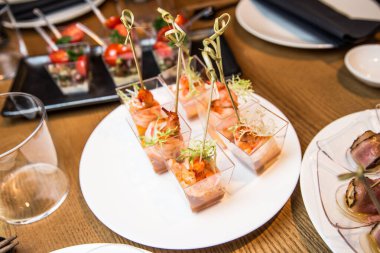 Beyaz arka planda lezzetli atıştırmalıklar olan yemek masası.