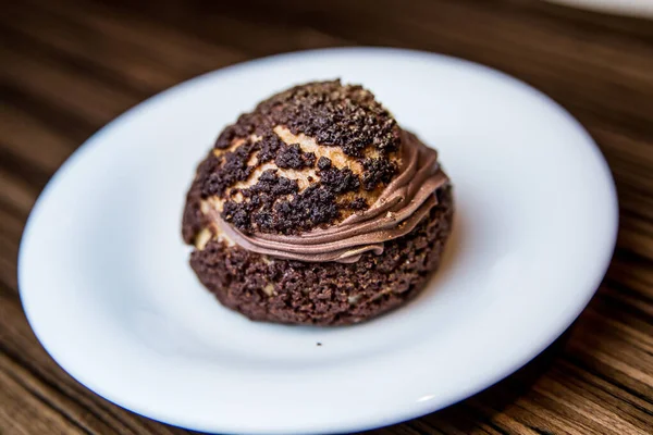 chocolate cake with nuts and cream on a plate