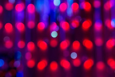 abstract background of red bokeh lights on purple background