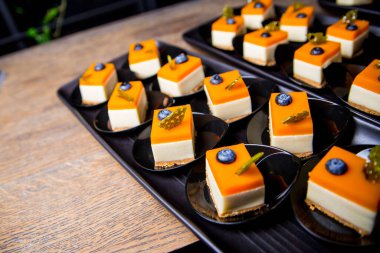 Dessert pudding on a black plates. Catering