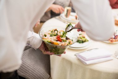 waiter serves salad. Catering 