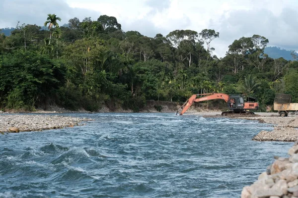 Aceh Barat Daya, Endonezya - 7 Ağustos 2022 Blangpidie Abdya 'daki hızlı su akışı seçici odak noktasında fotoğraflanan bir nehirde kumda kazı yapan bir ekvatator