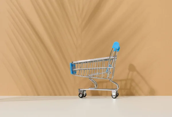 Empty Miniature Shopping Cart Brown Background Seasonal Sale Copy Space — Foto Stock
