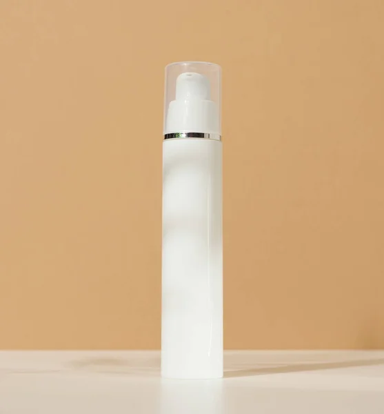 White Plastic Cosmetic Bottle Dispenser Transparent Cap Brown Background Packaging — Stockfoto