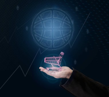 a man's hand holds a miniature shopping cart on a dark blue background, the concept of the start of world sales, the growth of purchases. Online shopping