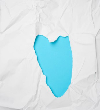 Buruşuk beyaz kağıt, kalp şeklinde bir delik.