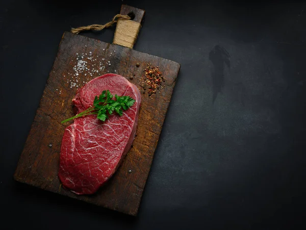 Raw Beef Tenderloin Lies Cutting Board Spices Cooking Black Table — Foto de Stock