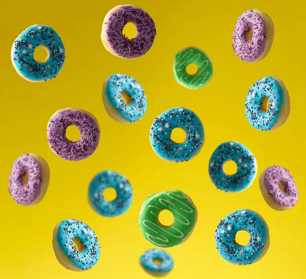 Multi Colored Donuts Sprinkled Sugar Sprinkles Fly Yellow Background Delicious — Stok fotoğraf