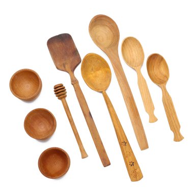 Empty wooden spoons and wooden bowls on a white isolated background, top view