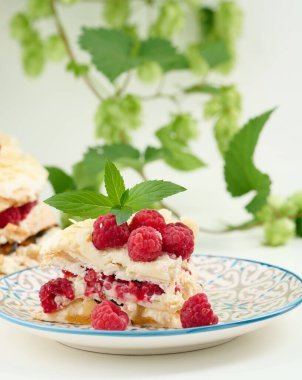 Round meringue pie with fresh raspberries on a white background, Pavlova dessert