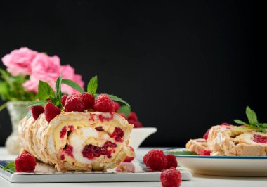 Baked meringue roll with cream and fresh red raspberry 
