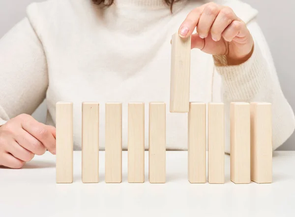 Wooden Blocks Table Woman Hand Holds One Concept Finding Unique — стоковое фото