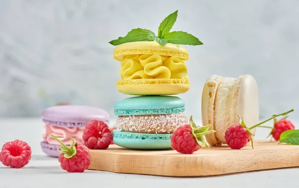 Stack Multicolored Macaroons Red Raspberries White Background Delicious Dessert — Zdjęcie stockowe