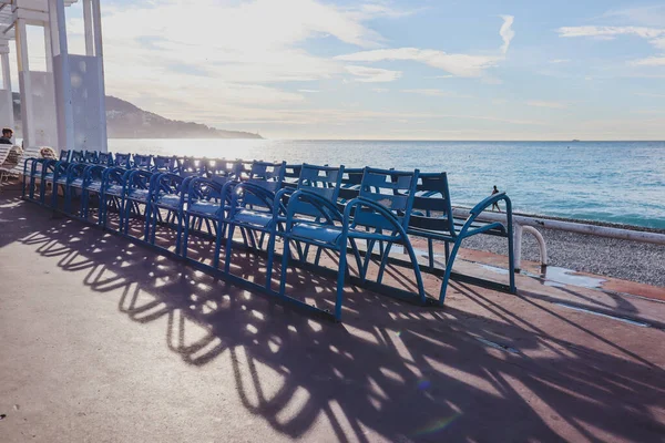 Nice, France - 29.09.2022 :  Famous blue chairs on the Promenade des Anglais in Nice