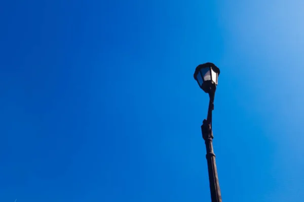 Isolated garden lamp on a clear blue sky background