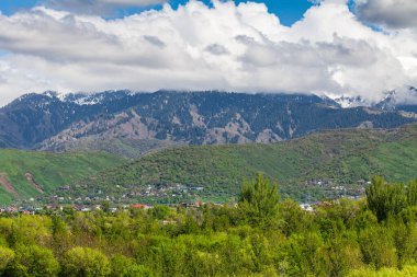 The Zailiyskiy Alatau Mountains in Almaty, Tien Shan mountain system in Kazakhstan. Big Almaty Gorge. Beautiful clouds.