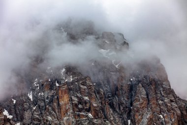 lonely brutal rock among the descending clouds, Almaty, Kazakhstan