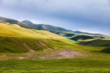 Mountain river in the valley of the Assy plateau. Nomads live in yurts. Asia, Kazakhstan
