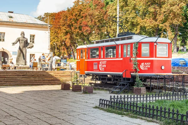 Lviv, Ukraine - August 18, 2021: Old red city tram converted into a street cafe. Creative street cafe in the city of Lviv.