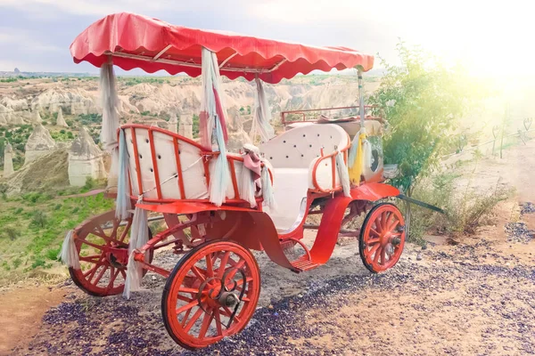 Vintage red wedding royal carriage against the background of the mountains in Cappadocia