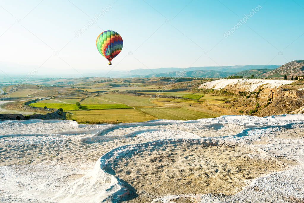 Multi-colored balloon flies over Pamukkale , Turkish mineral calcium pool