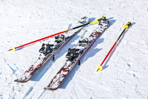 Pair of skis and ski poles in the snow