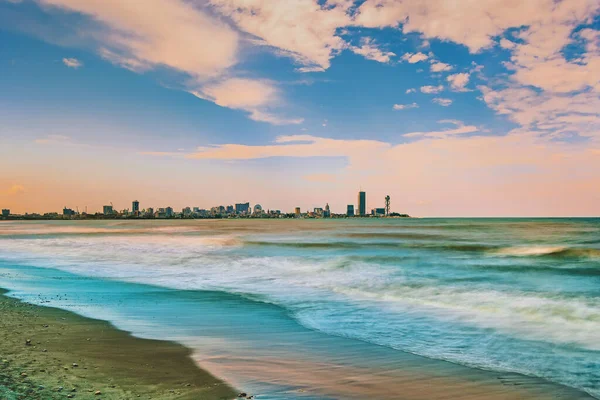 Beautiful Batumi, Georgian resort city and port at Black Sea - panoramic view of city centre from sea in golden summer morning sunlight