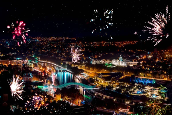 Beautiful night landscape with salute and fireworks in Tbilisi city, Georgia