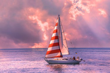 Boat with the flag of Ukraine and the inscription Viking in the foreground. Summer water sports, outdoor adventure. Sunset sky in the background.