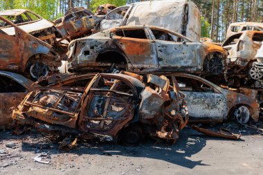 Many shot and destroyed cars at the car graveyard in Irpin, Ukraine. irpin car cemetery