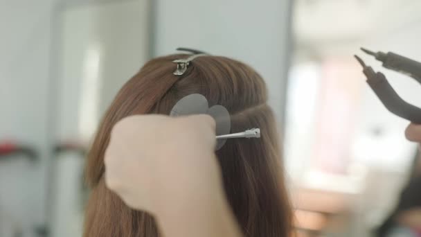 美容師は本物に人工毛を固執します 髪の延長のプロセス — ストック動画