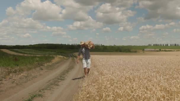 Young Caucasian Farmer Man Hat Walking Field Sack Grain Looking — Stockvideo