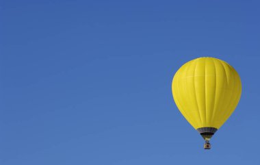 Yellow Hot air balloon on one side of the sky with copy space