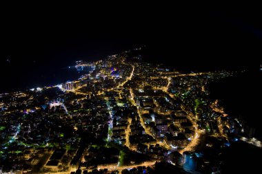 İyi geceler. Karadağ. Adriyatik Denizi kıyısında. Drone. Hava görüntüsü. Budva şehri. Şehir ışıkları. Popüler turizm merkezi