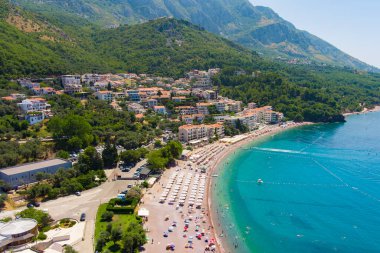 Karadağ. Adriyatik Denizi. Sveti Stefan plajı. Yaz. Güneşli bir hava. En iyi sezon. Çok popüler bir turistik yer. Drone. Hava görünümü