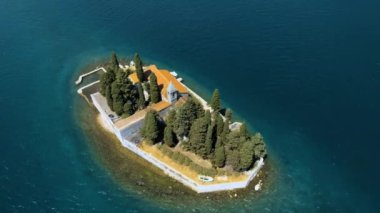 Karadağ. Kotor Körfezi. St. George Adası, Perast şehrinin yakınında yer almaktadır. Popüler turist mekanı. Drone. Kamera dönüyor.