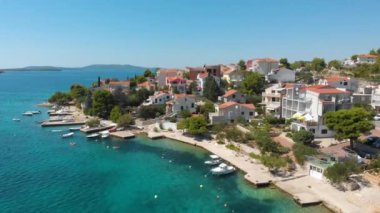 Croatia. Coast of the Adriatic Sea. Small town by the sea. Summer. Tourist season. Popular place to relaxation. Drone. Aerial view. The camera moves up