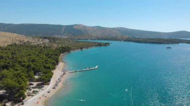 Croatia. Bay on the coast of the Adriatic Sea. Summer. Tourist season. Popular place to relaxation. Drone. Aerial view. The camera moves forward