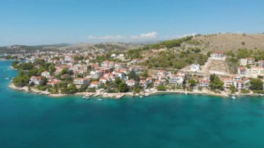 Croatia. Coast of the Adriatic Sea. Small town by the sea. Summer. Tourist season. Popular place to relaxation. Drone. Aerial view. The camera moves from right to left