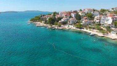 Croatia. Coast of the Adriatic Sea. Small town by the sea. Summer. Tourist season. Popular place to relaxation. Drone. Aerial view. The camera moves down