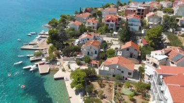Croatia. Coast of the Adriatic Sea. Small town by the sea. Summer. Tourist season. Popular place to relaxation. Drone. Aerial view. The camera moves forward