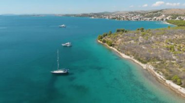Croatia. Bay with yachts on the Adriatic coast. Summer. Tourist season. Popular place to relaxation. Drone. Aerial view. The camera moves up