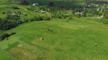 Ukraine. Rural hilly area. Summer. Farm. Ecologically clean area. Drone. Aerial view. Flight over the green meadow. The camera moves up