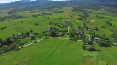 Ukraine. Rural hilly area. Summer. Farm. Ecologically clean area. Drone. Aerial view. Flight over the green meadow. The camera rotates