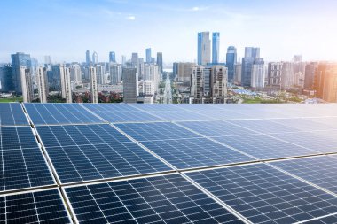 Photovoltaic panels in front of city background clipart