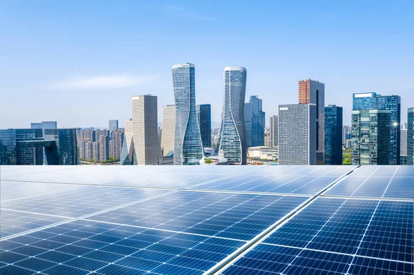 Photovoltaic panels in front of city background