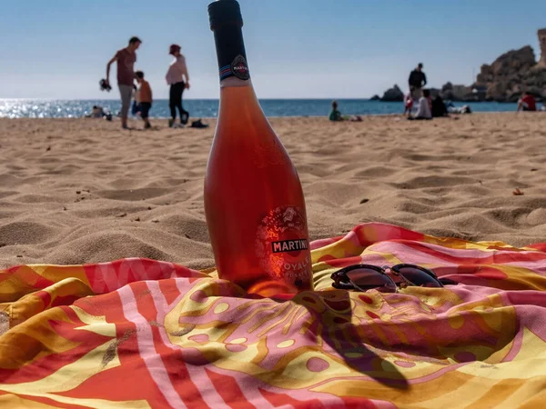 Bottle of Martini Royale Rosato on the beach